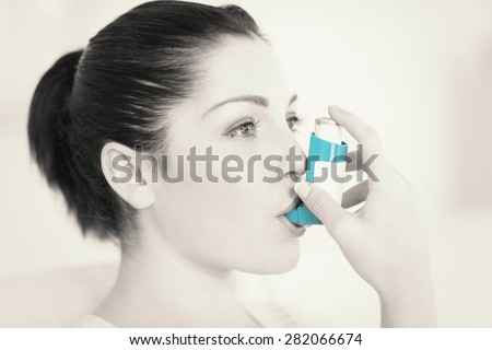 Woman having asthma using the asthma inhaler for being healthy