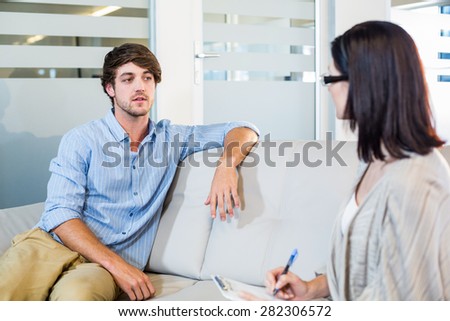 Psychologist talking with depressed man in the office
