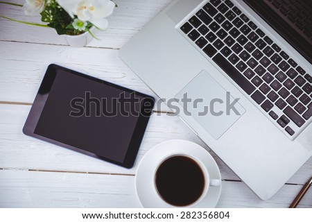 Overhead shot of laptop and tablet on a desk