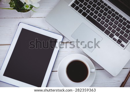 Overhead shot of laptop and tablet on a desk