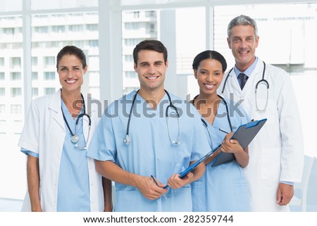 Portrait of confident doctors with arms crossed standing in medical office