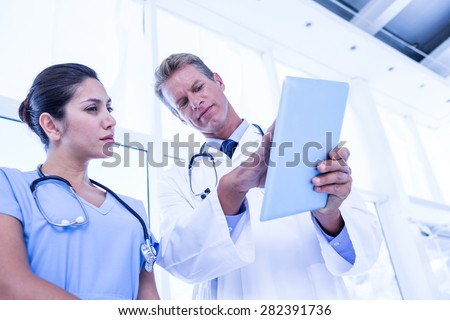 Nurse and doctor looking at tablet pc in the hospital