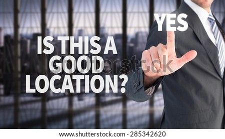 Businessman pointing with his finger against room with large window looking on city