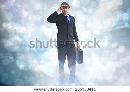 Businessman using binoculars while holding a briefcase against light glowing dots design pattern