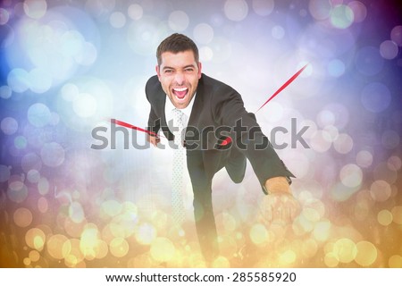 Businessman crossing the finish line against light glowing dots on purple