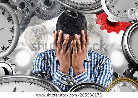 Young businessman with head in hands against white background with vignette