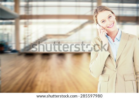 Businesswoman using her mobile phone against fitness studio