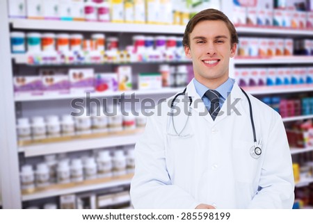 Young doctor using tablet pc against close up of shelves of drugs