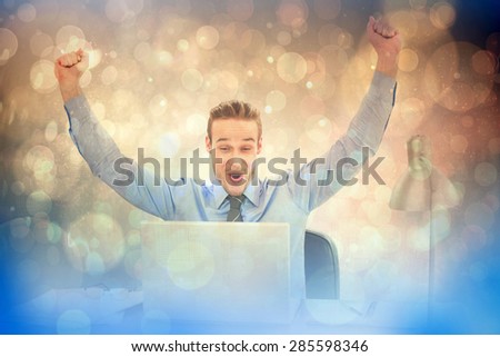 Cheering businessman at laptop against light glowing dots design pattern
