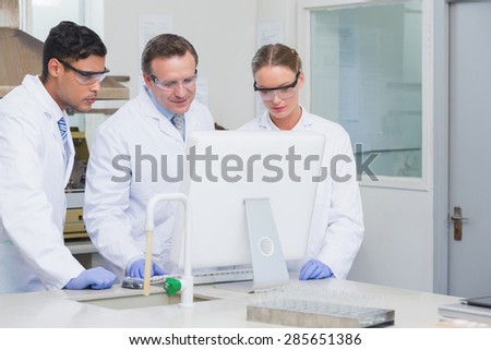 Scientists working on computer together on the laboratory