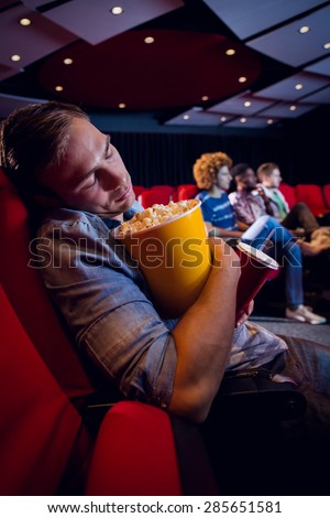 Young man sleeping at the cinema