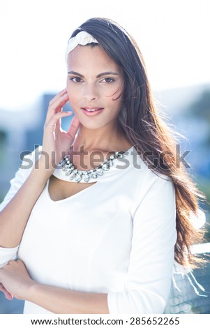 Beautiful woman well dressed looking at camera outside