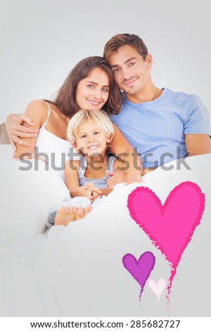 Lovely family embracing against valentines love hearts
