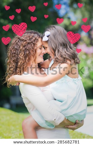 Red Hearts against happy mother and daughter hugging