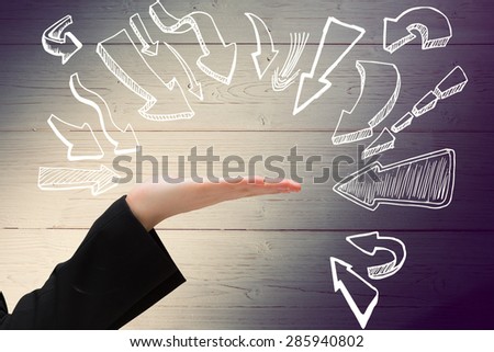 Hand presenting against shadow on wooden boards