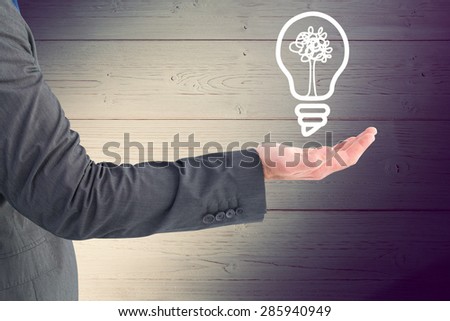Businessman holding his hand out against shadow on wooden boards