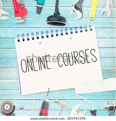 The word online courses against tools and notepad on wooden background