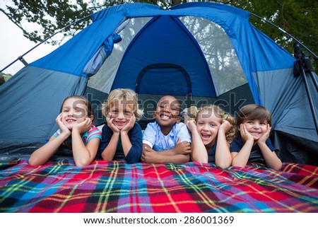 Happy siblings on a camping trip on a sunny day
