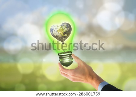 Businessman holding hand out in presentation against light glowing dots design pattern
