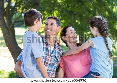 Happy family in the park together on a sunny day