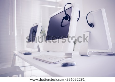 Computers and headsets in empty office