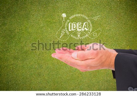Businessman holding his hands out against green background