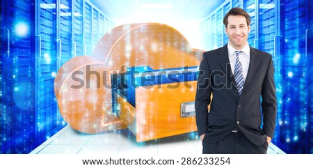 Smiling businessman standing with hands in pockets against digitally generated black and blue matrix