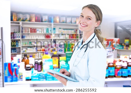 Doctor using tablet pc against close up of shelves of drugs