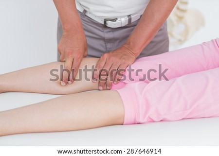 Doctor examining his patient leg in medical office