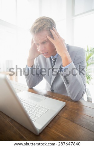 Depressed businessman at his desk in his office