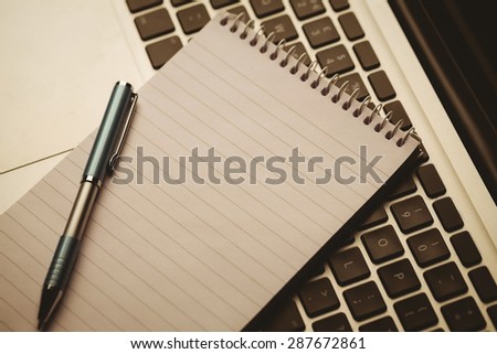 Notepad on laptop on a desk