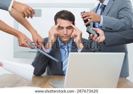 Worried businessman with head in hands sitting at the office