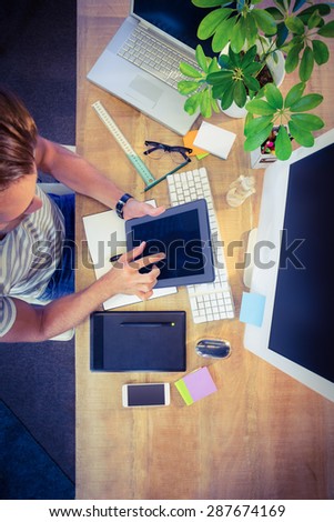 Designer working at desk overhead shot in creative office