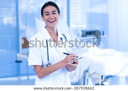 Nurse smiling at the camera in the hospital ward