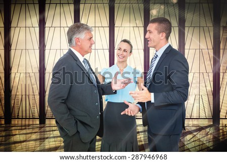 Business people standing and talking against window overlooking city