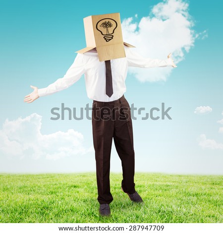 Anonymous businessman with arms out against blue sky over green field