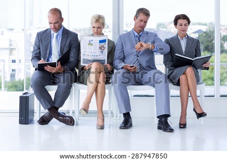 Business people waiting to be called into interview at the office