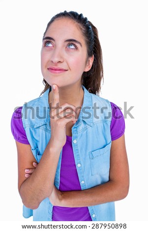 Pretty brunette thinking with finger on chin on white background