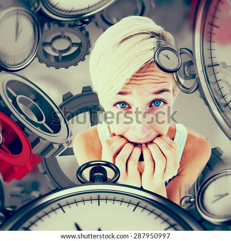 Stressed woman biting her nails against grey vignette
