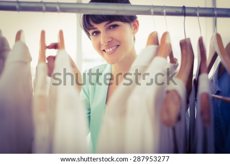 Portrait of a pretty girl looking trough the wardrobe