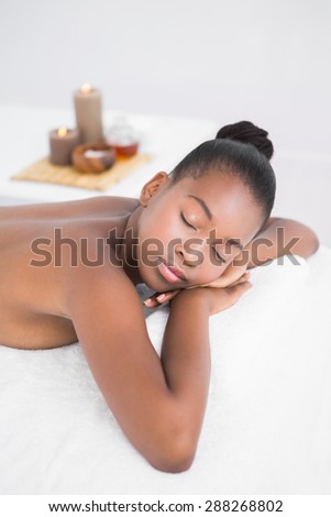 Peaceful pretty woman lying on massage table at the health spa