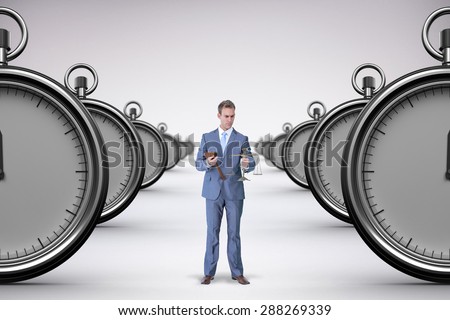 Businessman holding scales of justice against grey background
