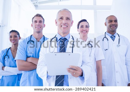 Team of smiling doctors looking at camera in medical office