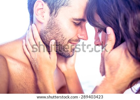 Happy cute couple hugging together at the beach