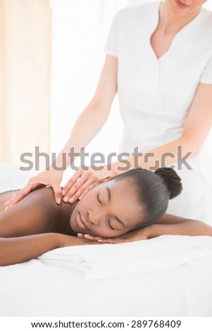 Pretty woman enjoying a massage at the health spa