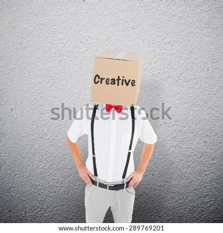 Anonymous businessman against grey wall
