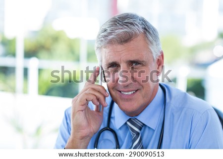 Doctor having phone call in medical office