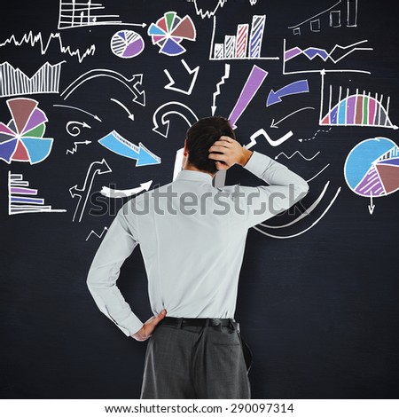 Thoughtful businessman with hand on head against blackboard