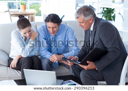 Couple in meeting with a financial adviser in living room