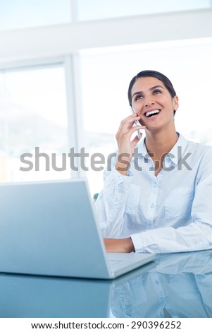 Smiling businesswoman having a phone call in an office